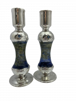 A silver candle holder with glass inside is high